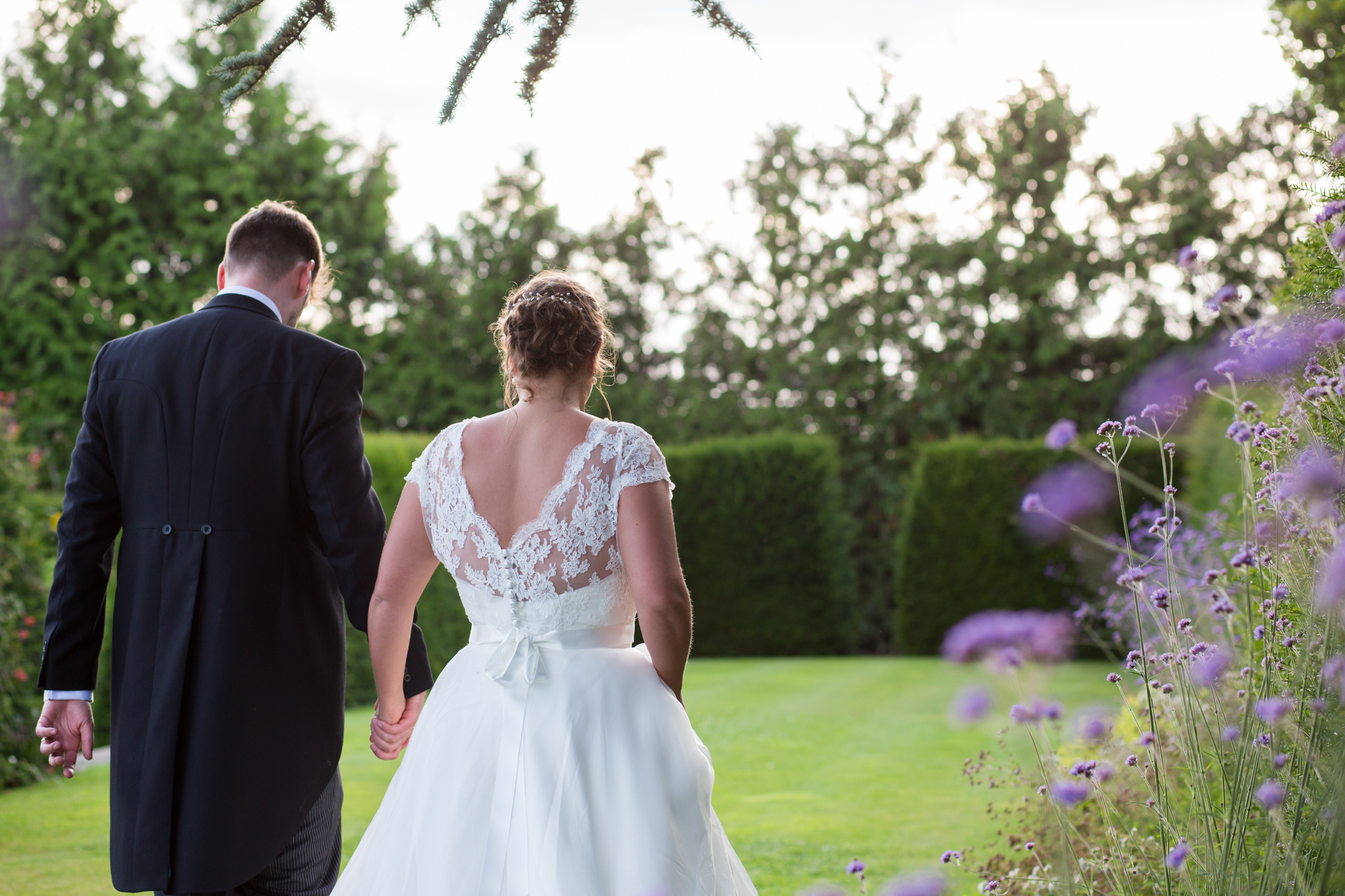 A wedding couple having their photos taken in Whatley Manor gardens